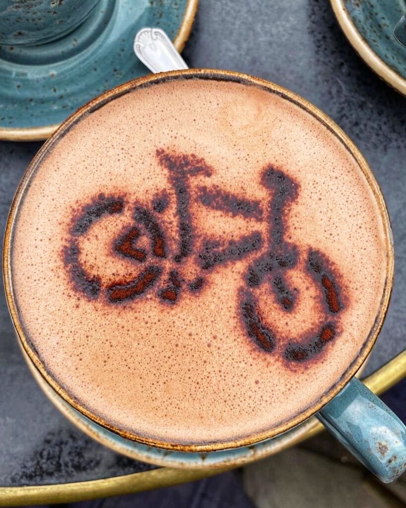 Coffee with chocolate sprinkles in shape of bicycle