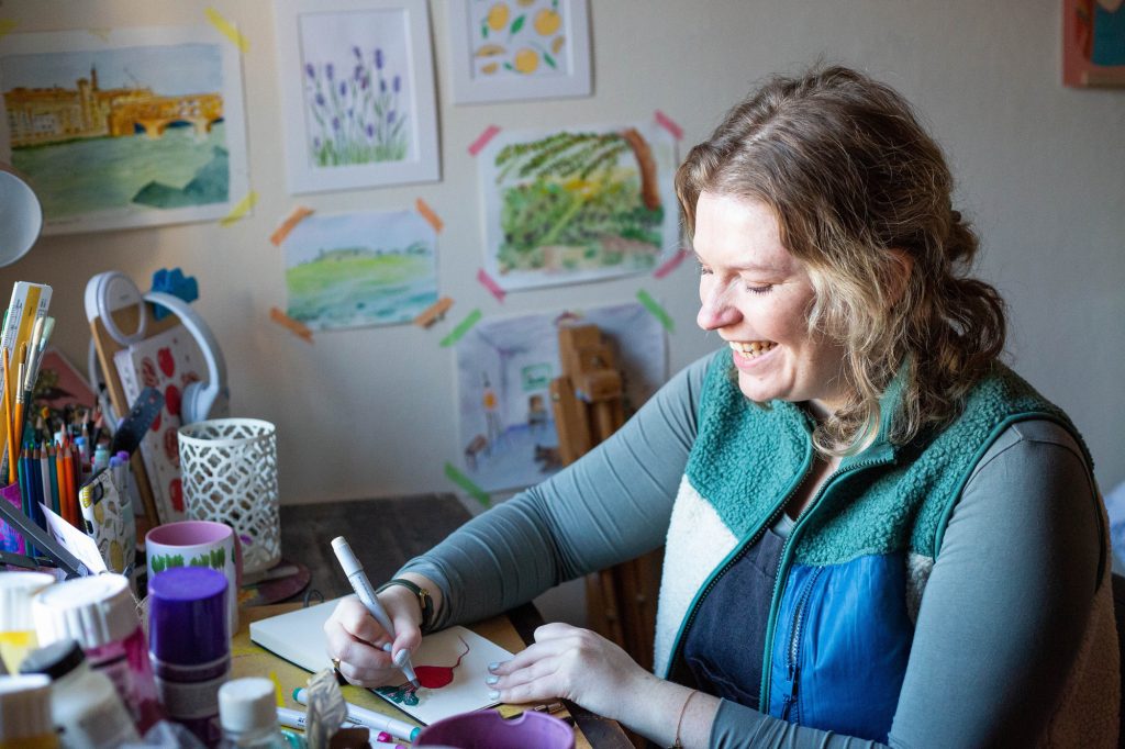 Alex illustrating at her desk