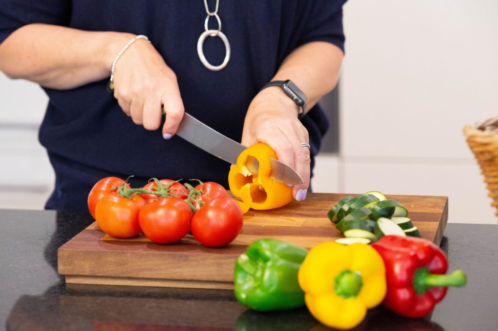 Hannah chopping fresh peppers