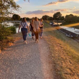 A group netwalking along the canal in the evening sun