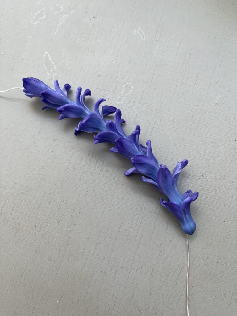 wire with many hyacinth petals threaded on