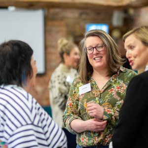 People talking and smiling at an event