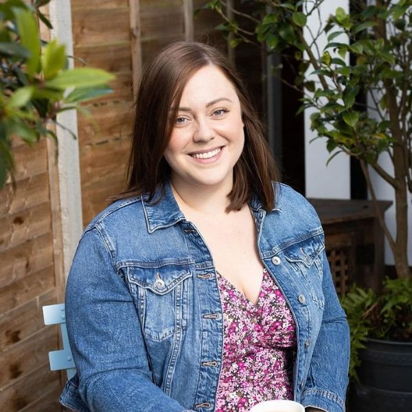 Beth sitting smiling at the camera