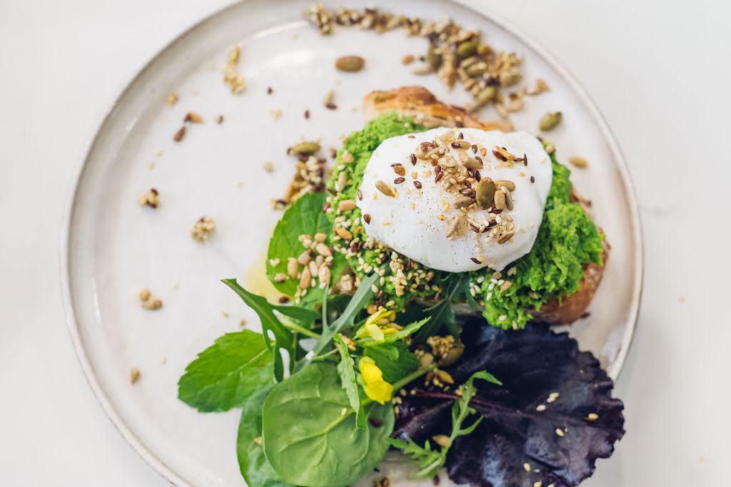 Poached Eggs with minted smashed peas on sourdough with toasted seeds