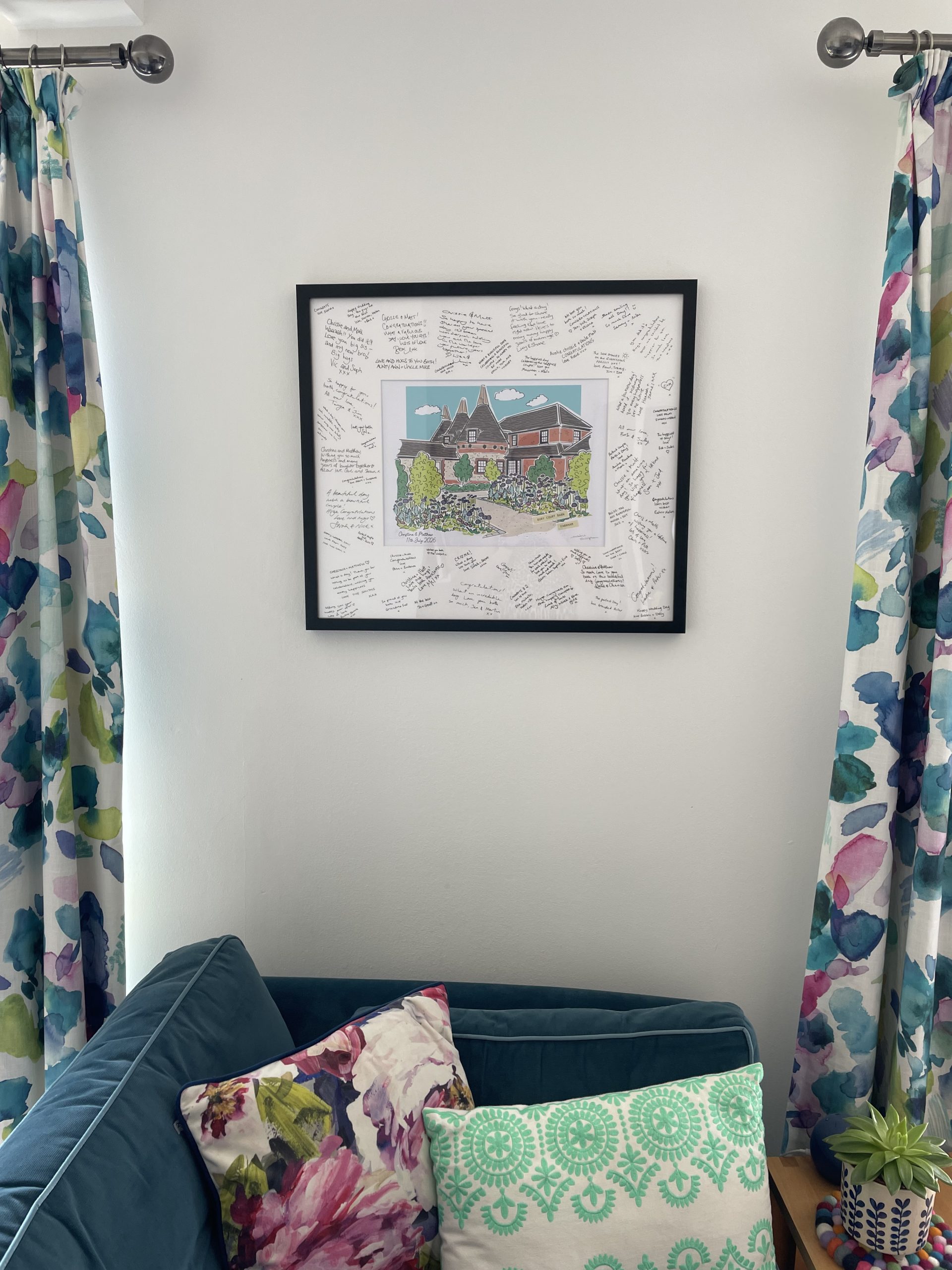 final signed wedding venue guest book hanging on the wall in a living room